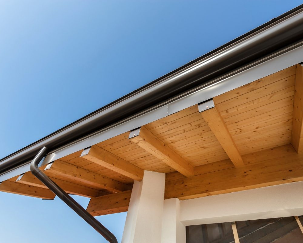 New wooden warm ecological house roof with steel gutter rain system